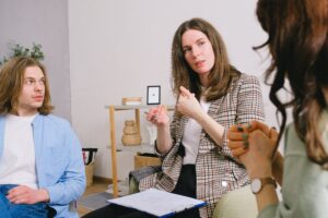 Facilitator speaking with two people