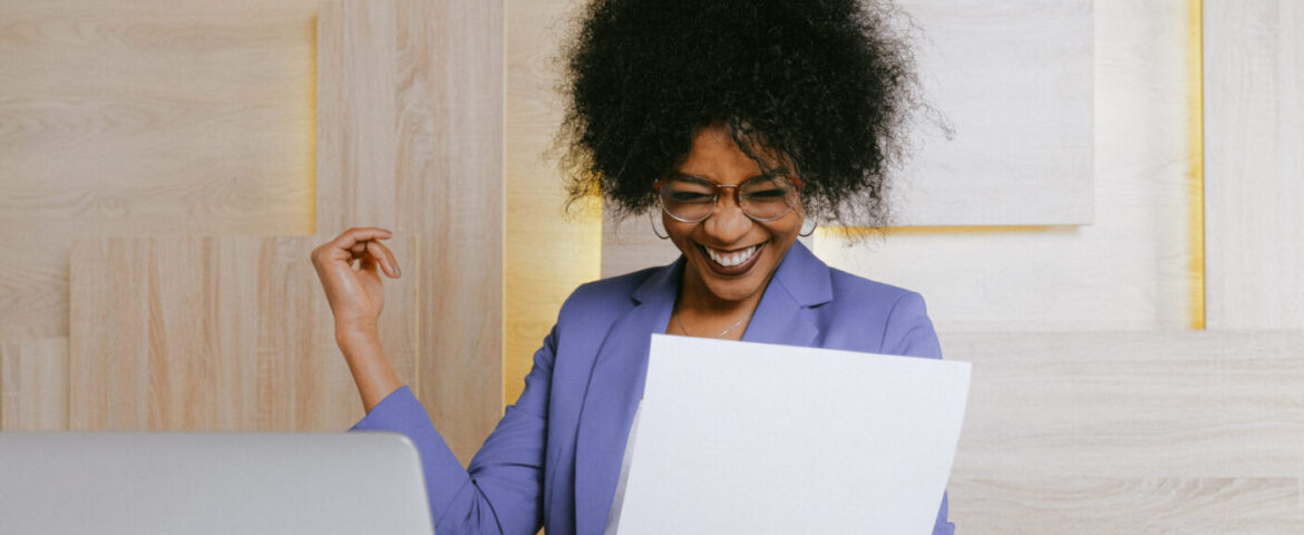 Woman reading a paper looking very happy